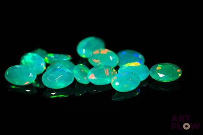 a close up of a bunch of green fire oplite stones