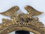 a mirror with an eagle on top of it