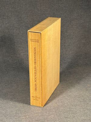 an old book with a wooden cover sitting on top of a table