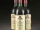 three bottles of red wine sitting on top of a table