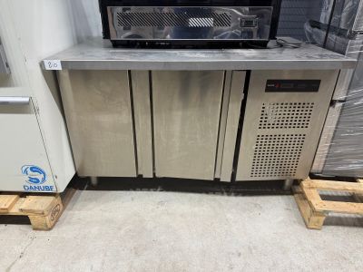 a microwave sitting on a pallet next to a refrigerator