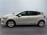 the silver car is parked on the concrete floor in the room