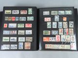 an open book with a lot of stamps on it sitting on top of a table