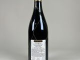 a bottle of wine sitting on top of a white table