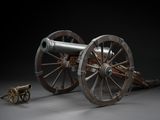 a cannon sitting on top of a wooden wheel