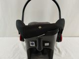 a baby car seat that is on a white surface