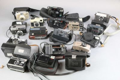 a lot of cameras that are sitting on a table