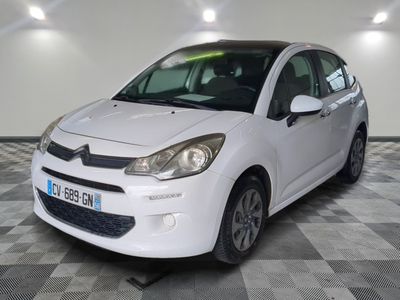 the white car is parked on a checkered floor in the garage