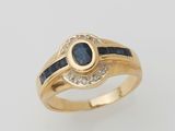 a yellow gold ring with a sapphire and diamonds