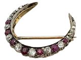 une broche antique en forme de croissant, sertie de rubis et de diamants