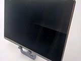 a black computer monitor sitting on top of a white table