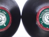 two black bottles with green and red labels on them