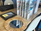 a table with magazines and a mirror on it