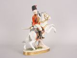 a figurine of a man riding on a horse