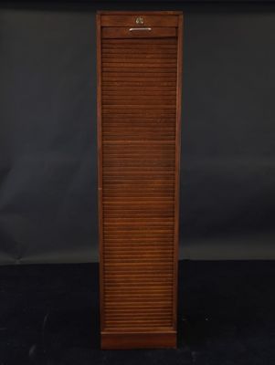 a tall wooden cabinet with shutters on top of it