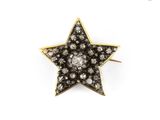 an image of a gold and diamond star broochle