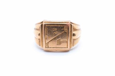 a close up of a gold signet ring on a white background
