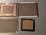 four pieces of cardboard are sitting on the floor next to each other