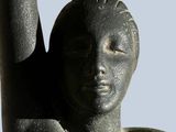 a statue of a woman with her arm raised