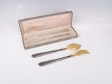 two forks and a knife in a wooden box on a white surface