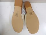 pair of women ' s shoes on a white surface with a box in the background