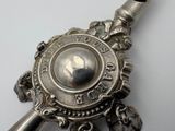a silver pendant with a picture of a woman on it