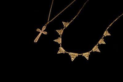 three gold necklaces with crosses and a cross on them