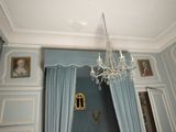 a chandelier hanging from the ceiling in a blue room