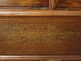 a close up of a wooden cabinet with a clock on top of it