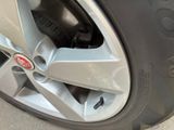 a close up of a tire with a red emblem on it
