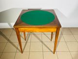 une petite table avec un plateau vert posée sur un sol carrelé
