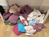 a pile of clothes on the floor next to a table