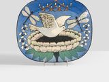 a small plate with a bird on it on a table