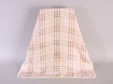 beige and brown checkered blanket on a white surface