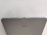 the back of an apple ipad sitting on top of a white bed