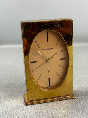 a gold clock that is sitting on a table