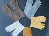 four pairs of gloves are arranged in a circle on a black surface