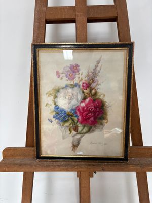 une photo d'un tableau représentant des fleurs posé sur un chevalet