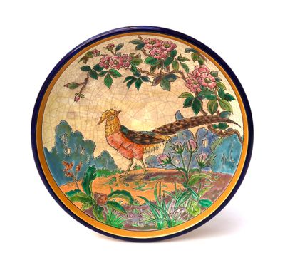 a decorative plate with a bird on it on a white background
