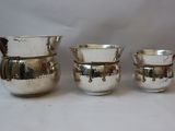 four pieces of silverware sitting on top of a white surface