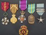 an assortment of medals including a star, a medal, a medal, a medal, and a medal