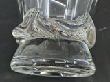 a glass vase with a design on it on a black surface