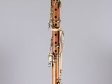 a close up of a bassoon on a stand on a grey background