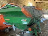a green and orange boat sitting on top of a pallet