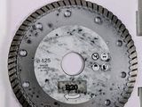 a close up of a diamond blade on a white surface