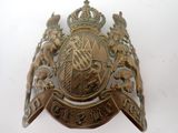 a metal badge on a white surface with a white background