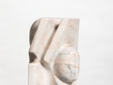 marble sculpture of a woman ' s face on a white surface