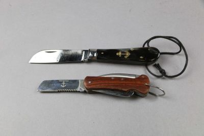 two knives and a knife holder on a table