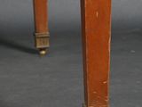 a close up of a wooden table with a black top and legs