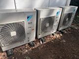 several air conditioners are lined up in a row on the side of a building